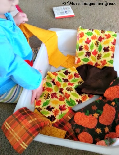 Infant sensory play for fall! Use fall fabrics for hands on exploration of colors of text