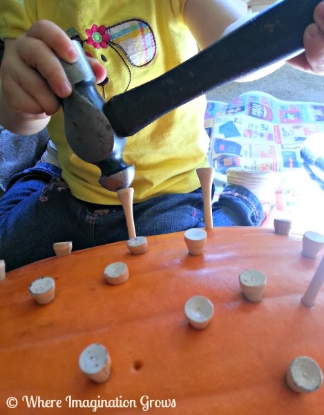 Hammering Nails into Pumpkins with toddlers and preschoolers! Great fine motor work for kids!