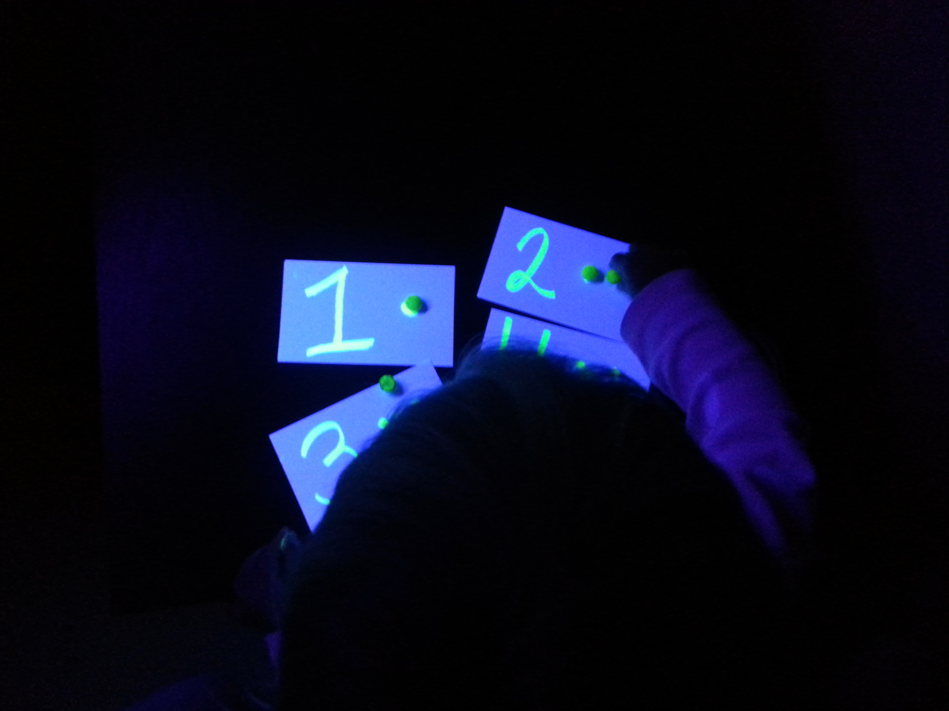 child counting with glow in the dark counting cards