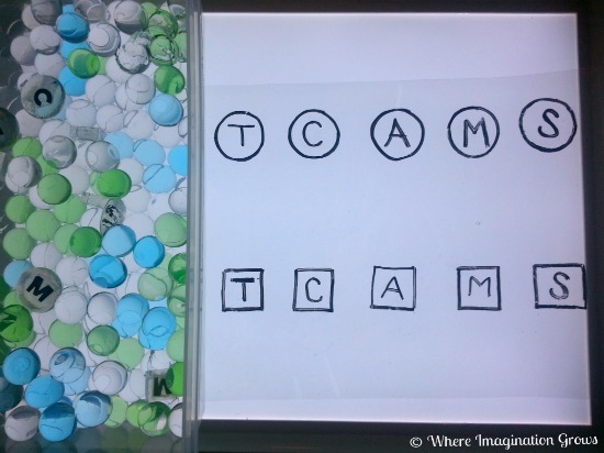 Water bead letter matching game for toddlers on the light table